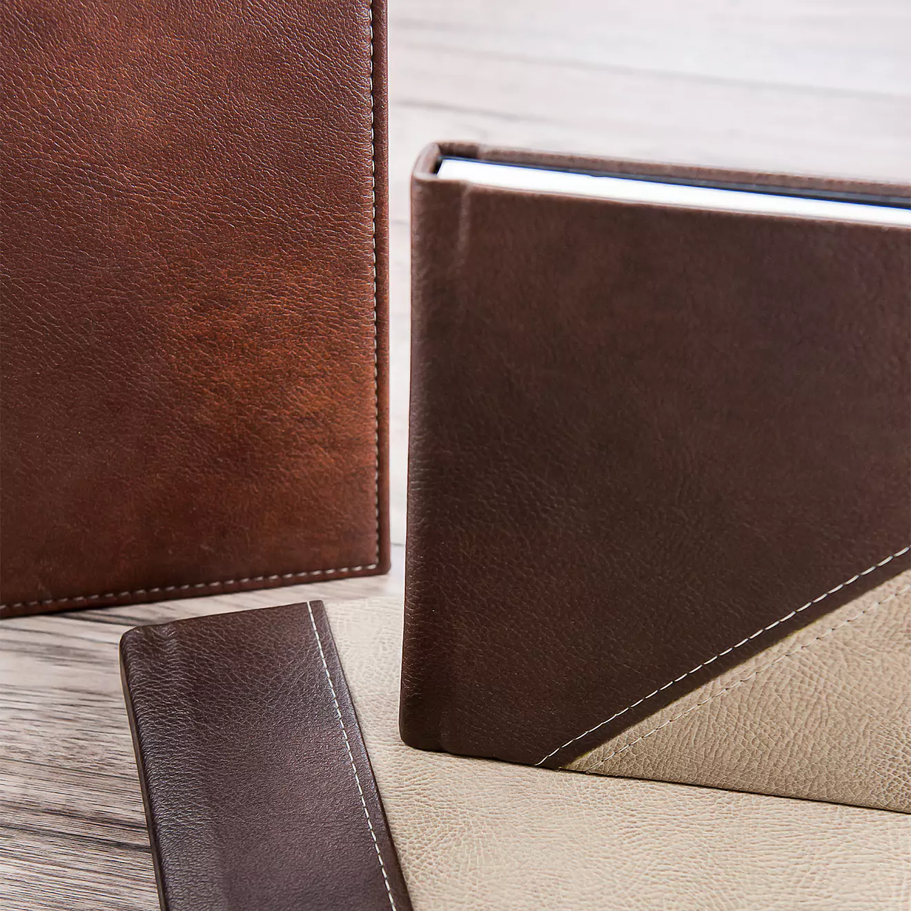 Elegant brown leather photo albums with stitched detailing, featuring a combination of dark and light brown covers. Ideal for preserving memories, these photo books make perfect gifts for men, baby showers, Christmas, or Valentine''s Day. Personalised gifts available in South Africa.