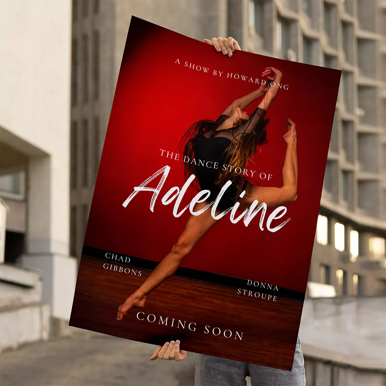 A person holding a large poster with a red background, featuring a dancer in a dynamic pose. The text on the poster reads "The Dance Story of Adeline" with additional details about the show and cast. The poster is held outdoors with a building in the background.