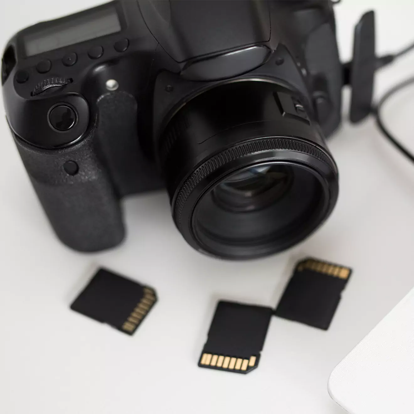 Camera placed alongside SD cards, ready for capturing and storing memories