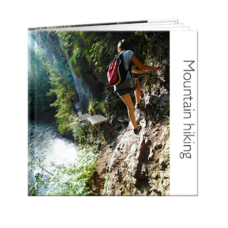 Photo book showcasing mountain hiking, featuring a person climbing a mountain on the front cover