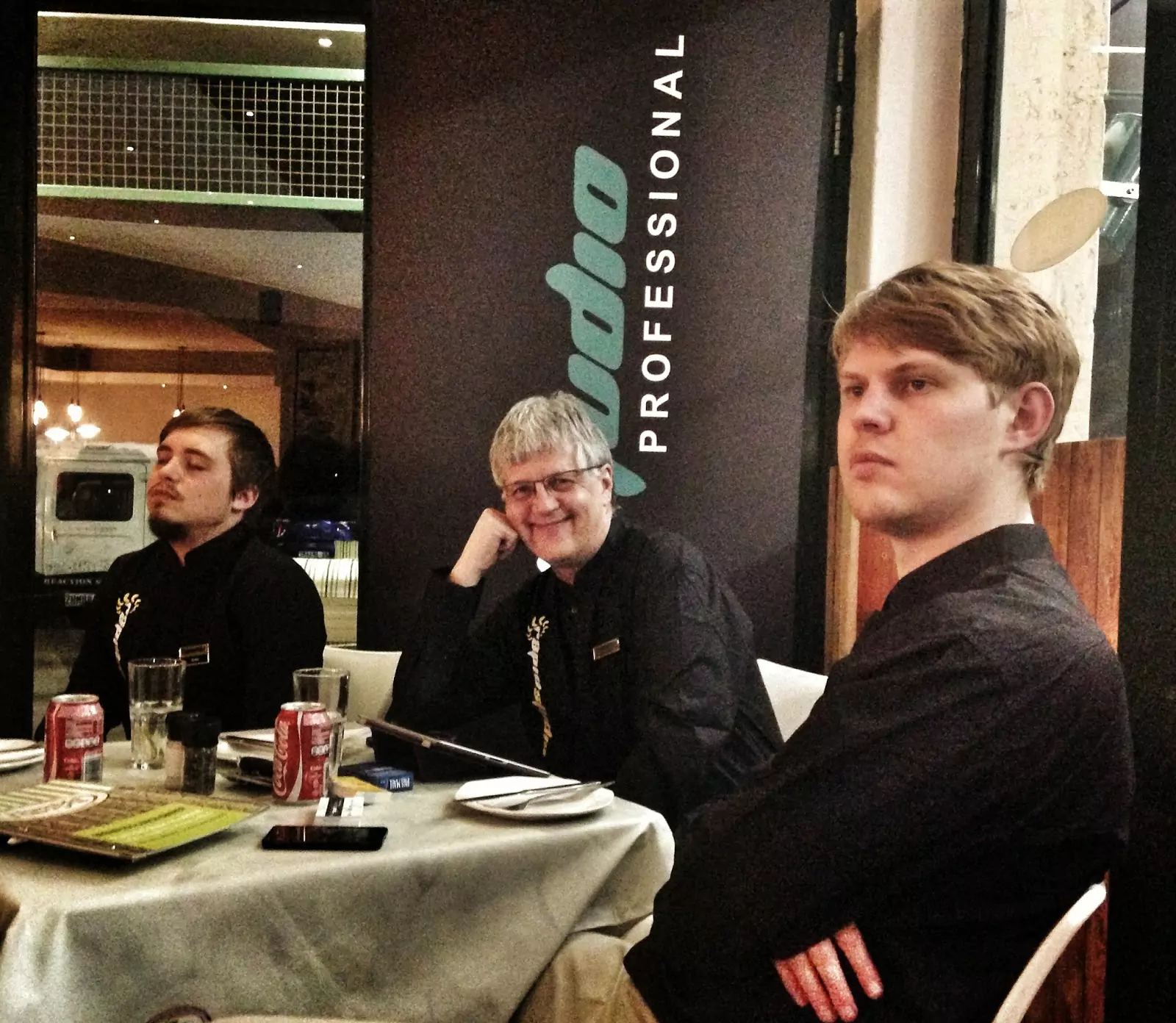 Three RapidStudio staff members sitting around a table at the event featuring Andrew Ross