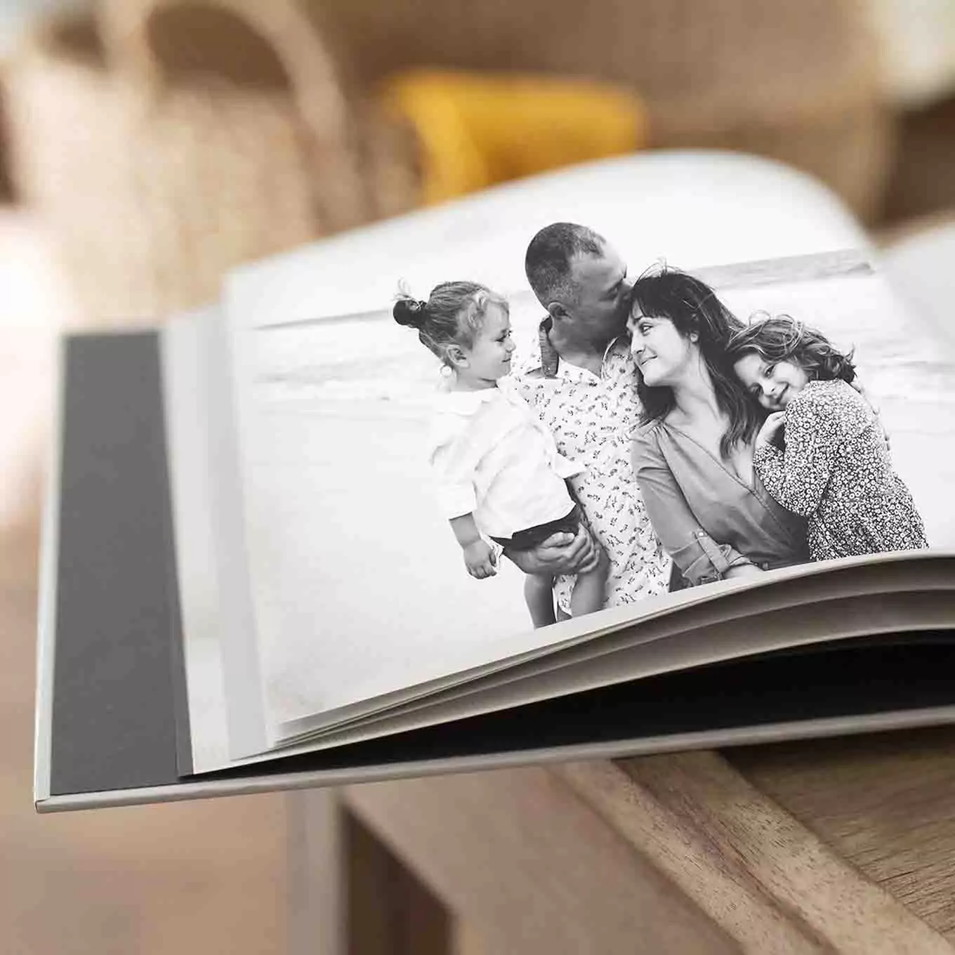 Open photo book featuring a loving family on one of the pages, created by RapidStudio