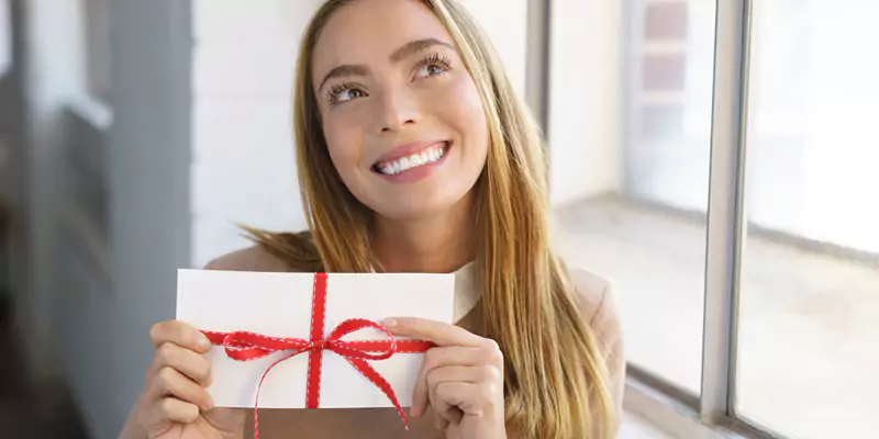 Woman holding a Christmas gift, ready to give or receive during the holiday season