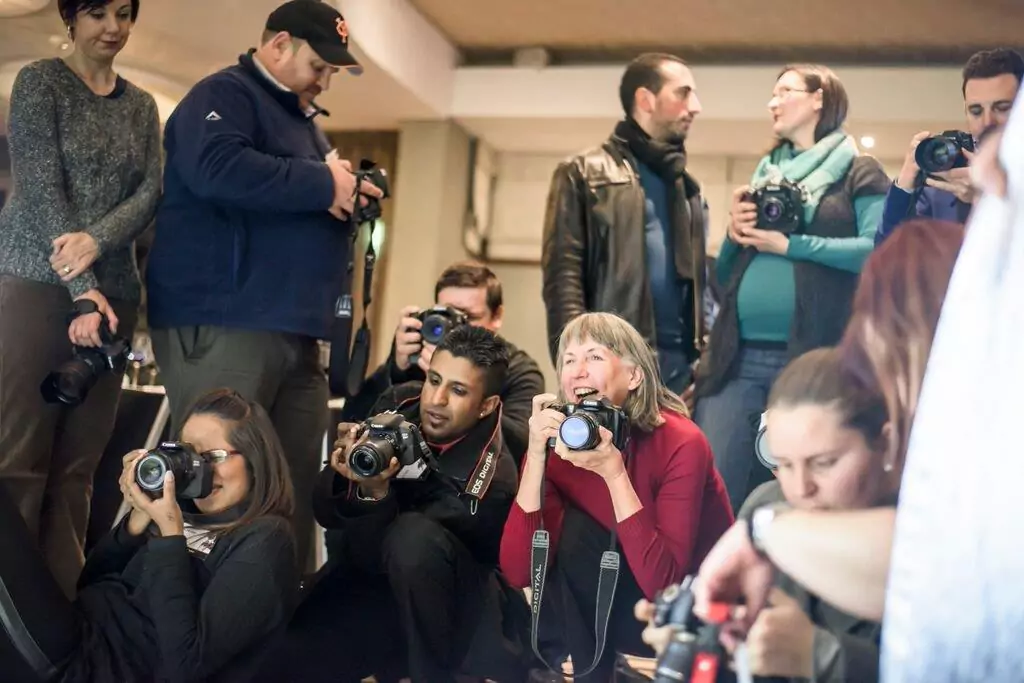 Photographers capturing shots during the Boudoir event, each working on their individual shoots