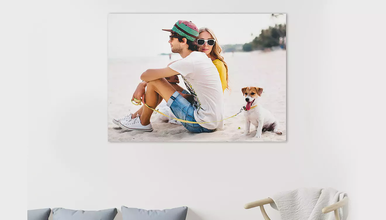 Canvas on the wall featuring a young couple with their dog, capturing a loving family moment - banner