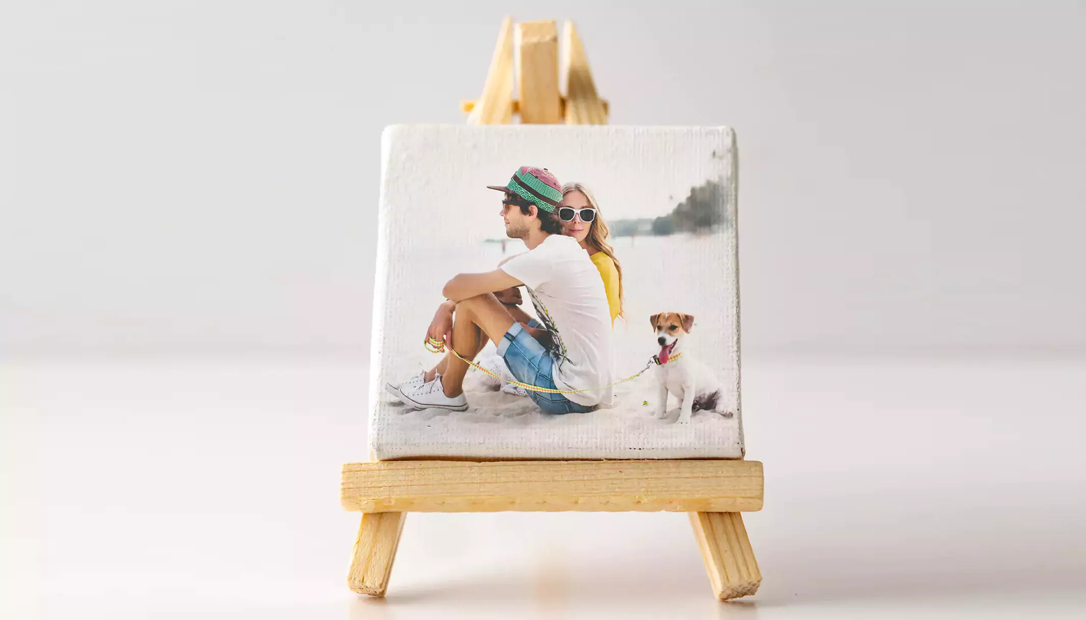 Mini-canvas called an Instablock, featuring a young couple on the canvas, displayed on an easel - banner