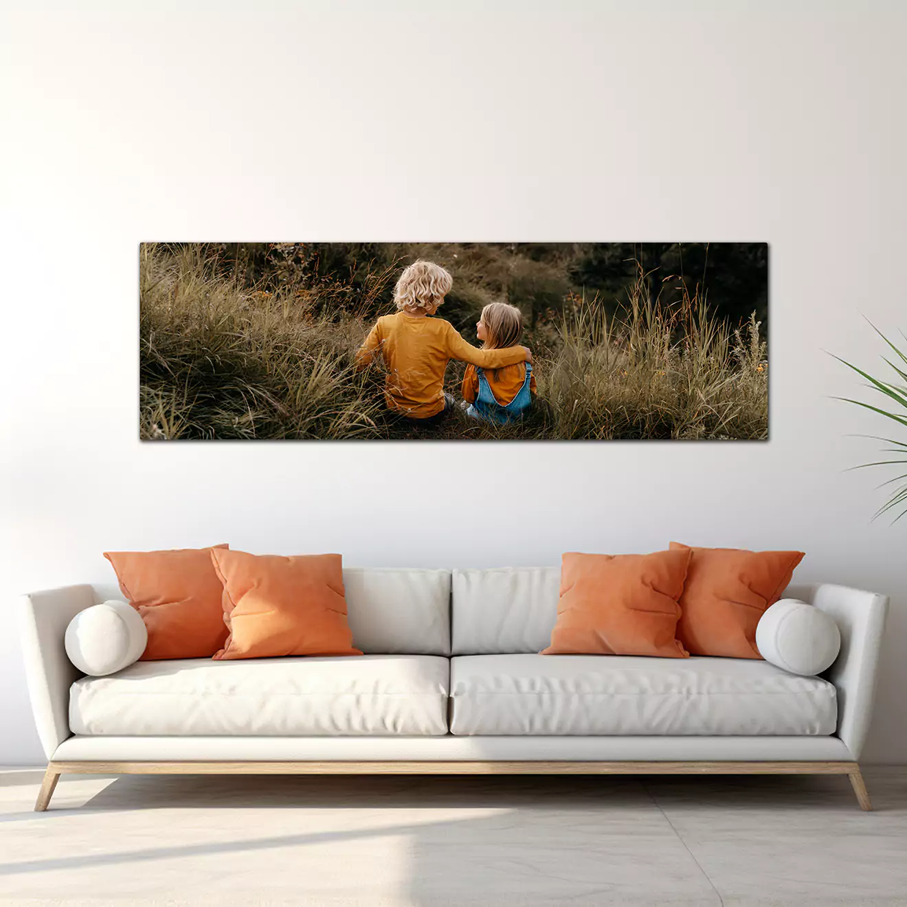 Panoramic canvas displayed in a lounge next to a couch, featuring two kids looking adoringly into each other's eyes