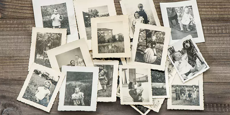 Old style photos lying on a table, evoking nostalgia and preserving memories