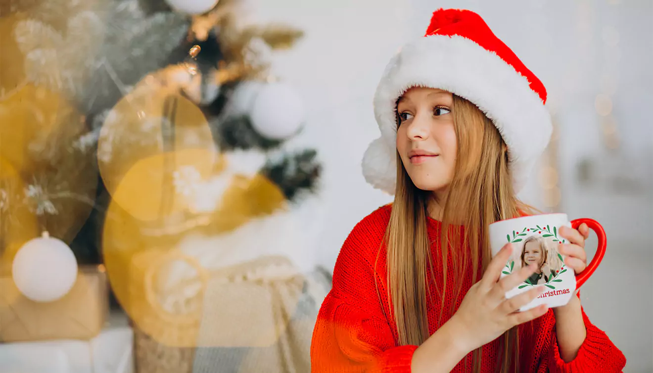 Young girl in a Christmas outfit holding a festive Christmas mug - banner