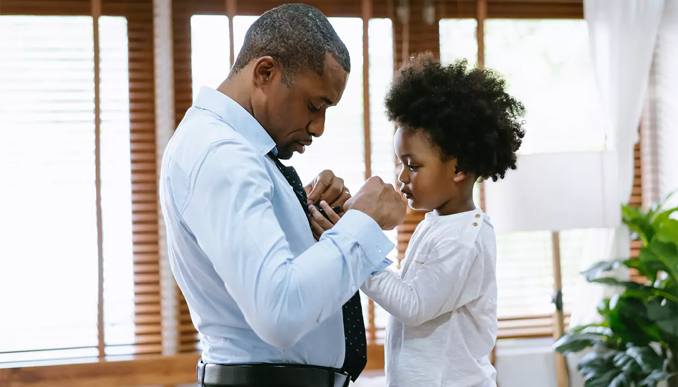 Child helping dad tie his tie, a heartwarming Father's Day moment - banner