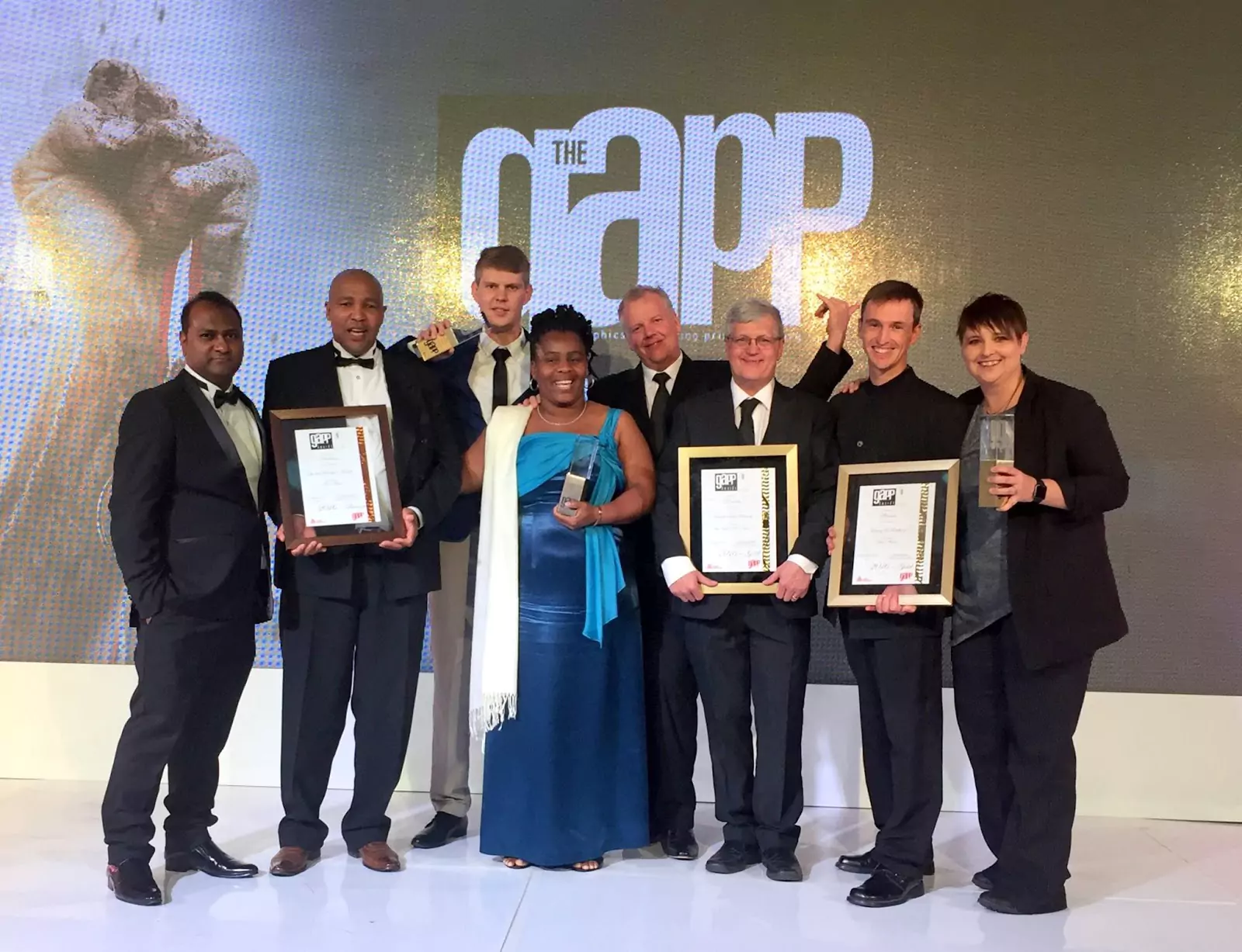 RapidStudio accepting their first, second, and third prizes at the GAPP Awards for the best photo book