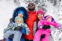 Family dressed in warm clothes for skiing, featured in their holiday photo book