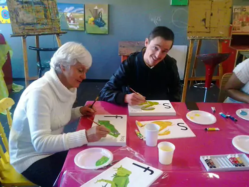 Another RapidStudio staff member and his mom painting for Nelson Mandela International Day, contributing to a collaborative and inspiring project