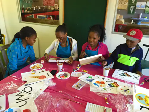 Celebrating Nelson Mandela International Day with kids painting on RapidStudio canvas, fostering creativity and community spirit