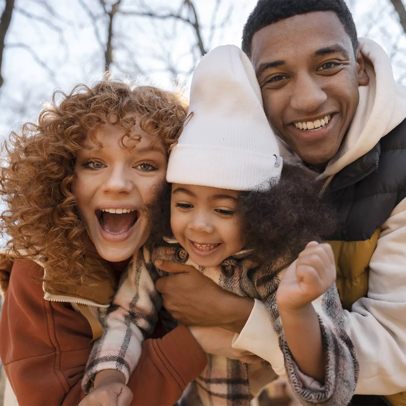 Beautiful family photo featuring mother, father, and child, capturing a loving and joyful moment