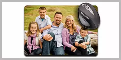 Phoneography! picture of a mouse pad featuring a family photo on it, showcasing a personalised touch for the workspace