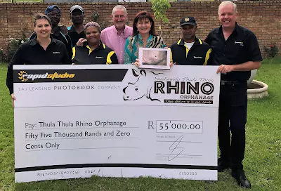 RapidStudio handing over a cheque to the Rhino Orphanage Charity, supporting wildlife conservation and rhino protection