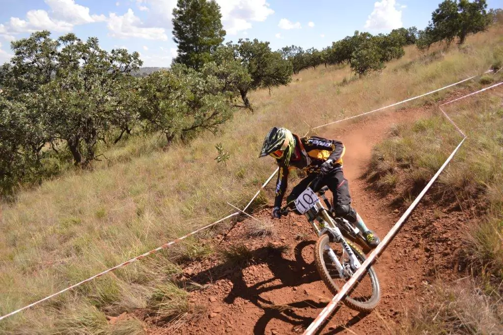 Boy racing through the corners at the Radman Rapid Studio downhill event, showcasing speed and skill on the track