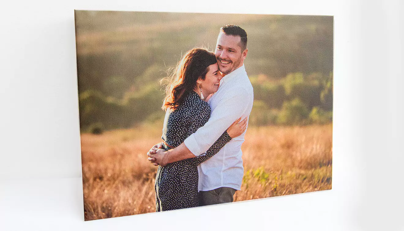 Picture of a loving couple mounted on a skinny canvas, creating a stylish and modern display of their special moment - banner