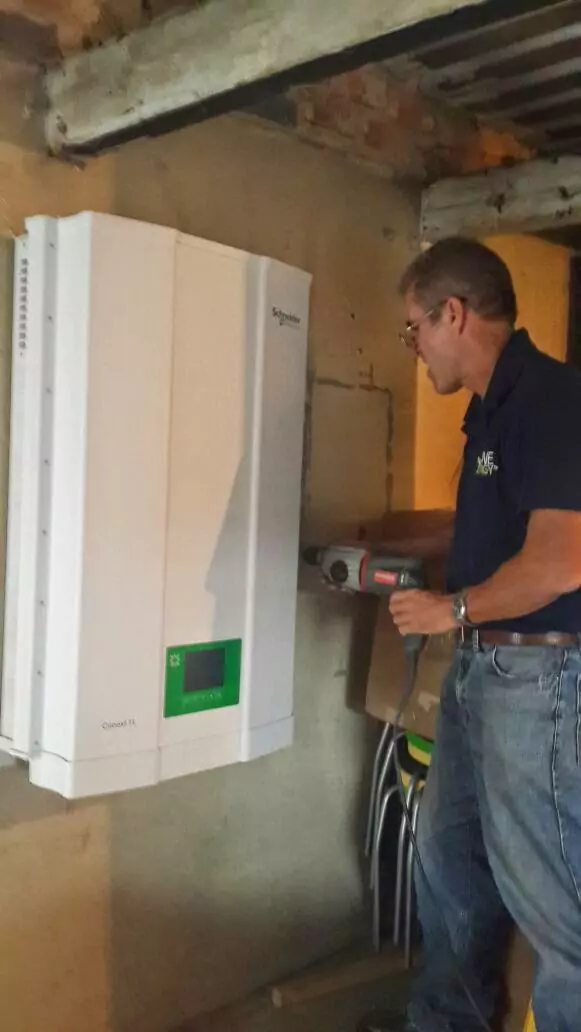 Installing the inverter at RapidStudio's factory, integrating it with the solar panel system for energy efficiency