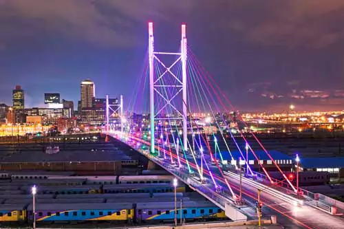 Stock photography of Johannesburg and the Nelson Mandela Bridge over the train station, perfect for a canvas, highlighting the city's iconic architecture