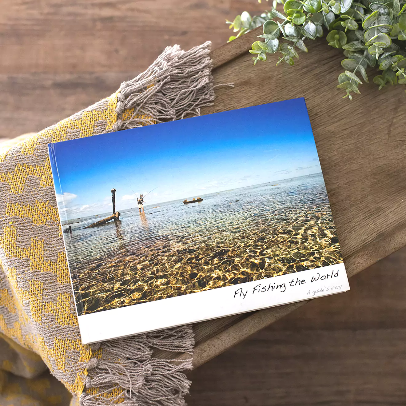 A beautiful fly-fishing coffee table photo book, capturing serene moments and stunning landscapes from the fishing adventure